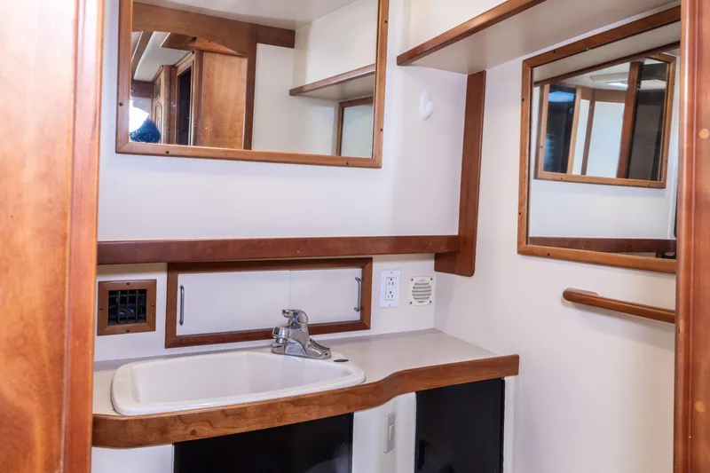 Slide: The Image of 2002 Sabreline 47 yacht bathroom with wooden accents and modern sink. - 10