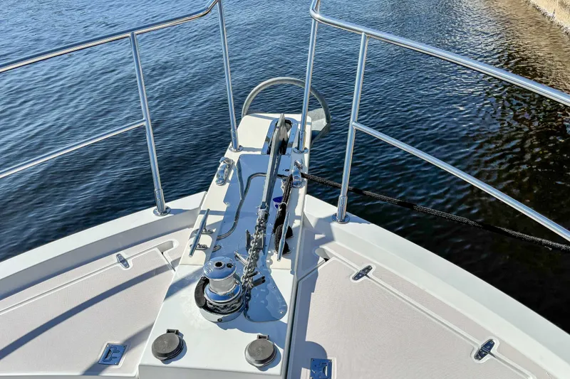 Slide: The Image of Bow of 2002 Sabreline 47 yacht with anchor and railing, on calm water. - 15