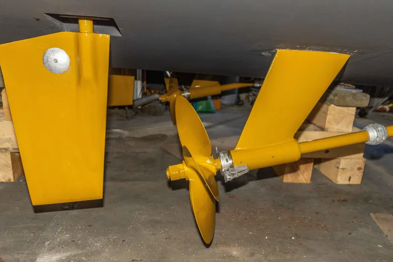 Slide: The Image of Yellow propeller and rudder of a 2002 Sabreline 47 boat in a workshop. - 18