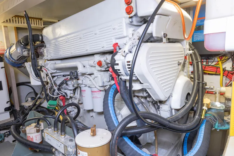 Slide: The Image of Engine room of a 2002 Sabreline 47 yacht, showcasing detailed machinery and components. - 19