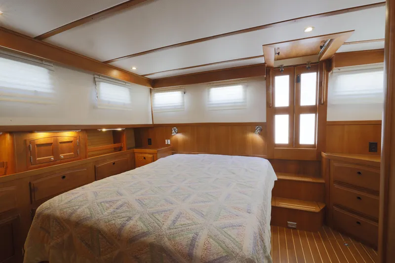 Slide: The Image of Luxurious 2002 Sabreline 47 yacht cabin with wood paneling and cozy bedding. - 9
