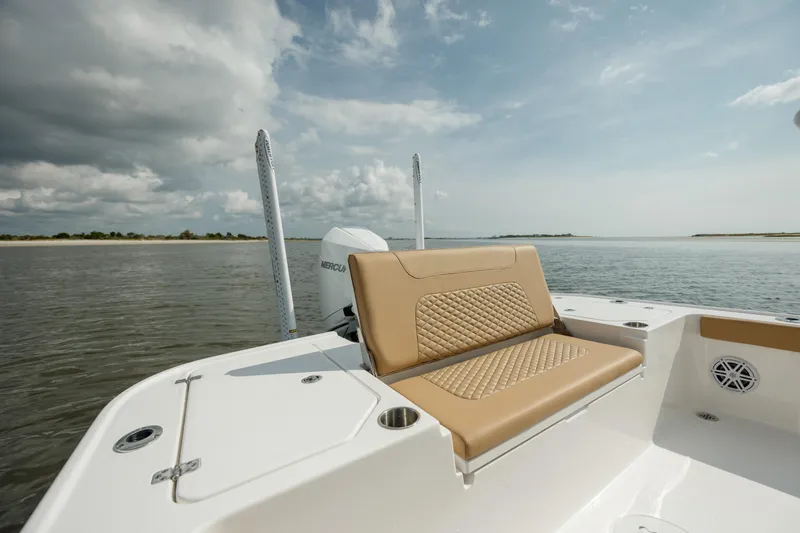 Slide: The Image of 2025 Caymas 26 HB boat with tan seating on calm water. - 11