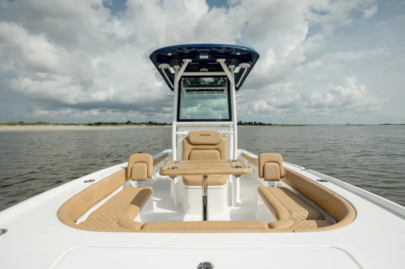 Slide: The Image of 2025 Caymas 26 HB boat on calm water under cloudy sky. - 21