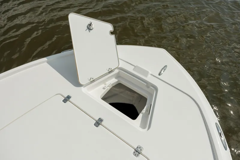 Slide: The Image of 2025 Caymas 26 HB boat with open storage compartment on deck. - 22