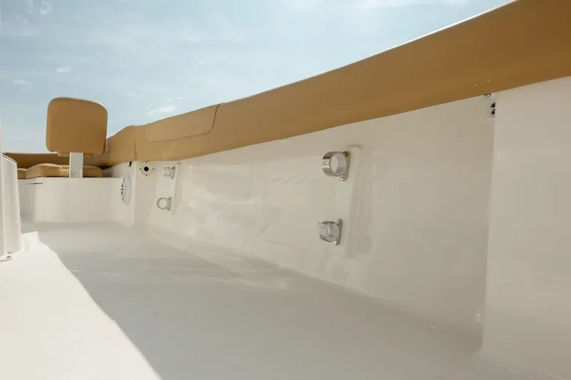 Slide: The Image of 2025 Caymas 26 HB boat interior with beige seating and sleek white finish. - 25