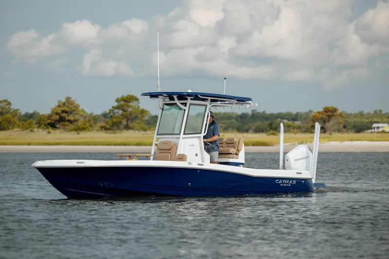 Slide: The Image of 2025 Caymas 26 HB boat cruising on a calm lake under a cloudy sky. - 3