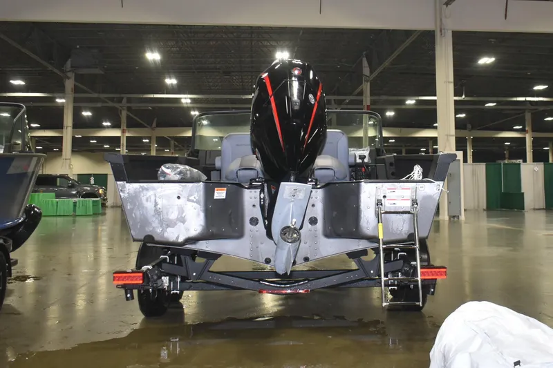 Slide: The Image of 2026 Alumacraft Competitor 195X Sport boat displayed indoors, rear view. - 3