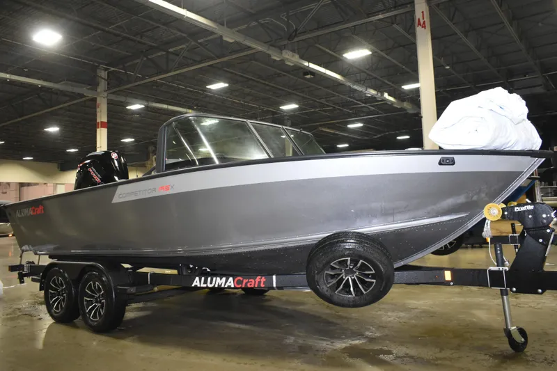 Slide: The Image of 2026 Alumacraft Competitor 195X Sport boat on trailer in indoor setting. - 4