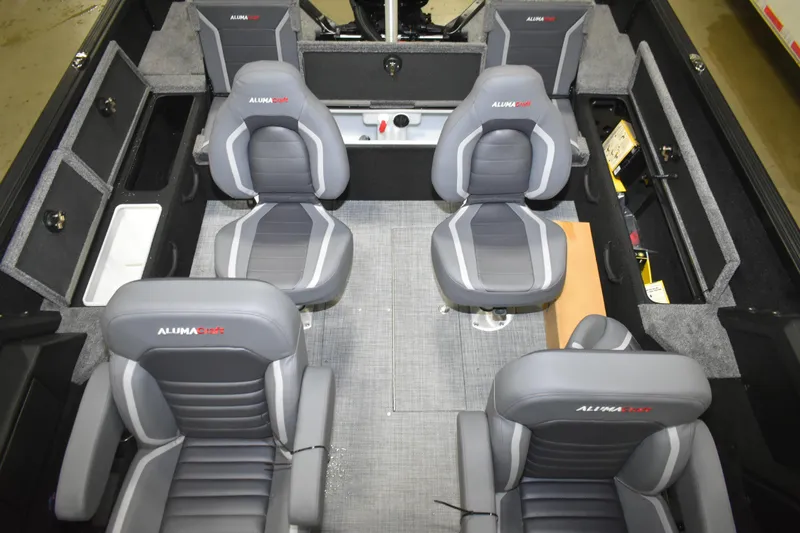 Slide: The Image of 2026 Alumacraft Competitor 195X Sport interior with gray seating and storage compartments. - 6