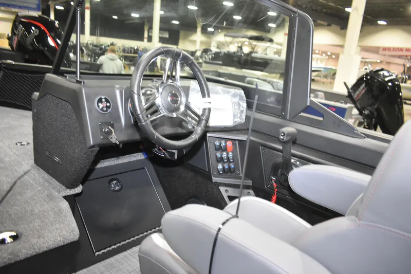 Slide: The Image of 2026 Alumacraft Competitor 195X Sport boat interior with steering wheel and control panel. - 7