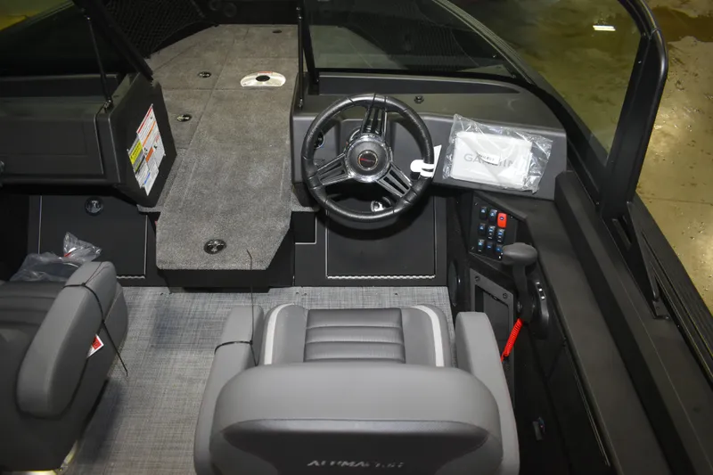 Slide: The Image of 2026 Alumacraft Competitor 195X Sport interior with steering wheel and Garmin equipment. - 9