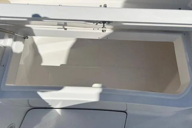 Slide: The Image of Open storage compartment on 2018 Everglades 335 Center Console boat. - 12