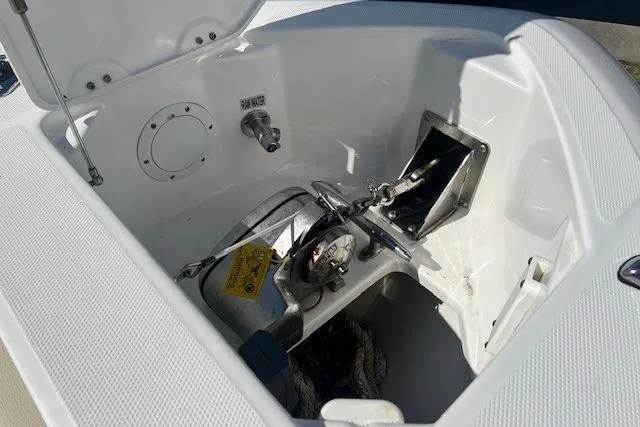 Slide: The Image of Anchor compartment of 2018 Everglades 335 Center Console boat, featuring a neatly stored anchor. - 14