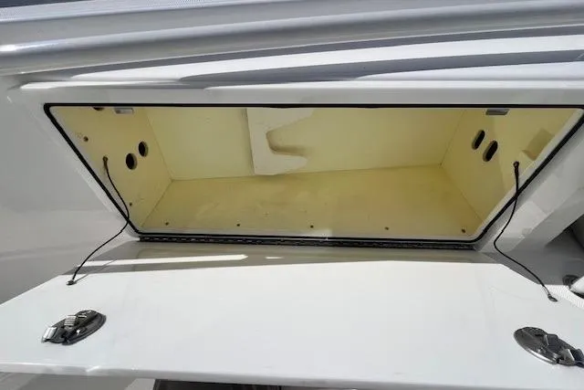 Slide: The Image of Open storage compartment on 2018 Everglades 335 Center Console boat. - 16