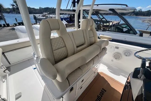 Slide: The Image of 2018 Everglades 335 Center Console boat interior with luxurious seating and waterfront view. - 19