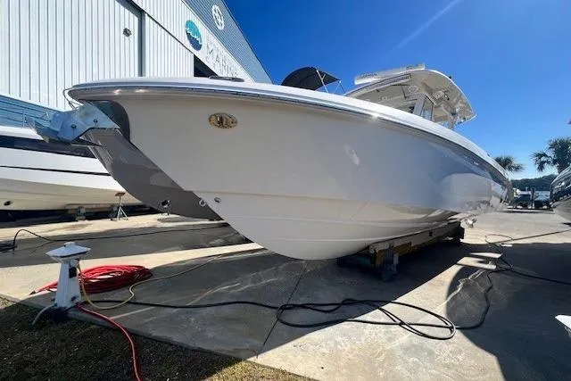 Slide: The Image of 2018 Everglades 335 Center Console boat displayed outdoors under clear blue sky. - 2