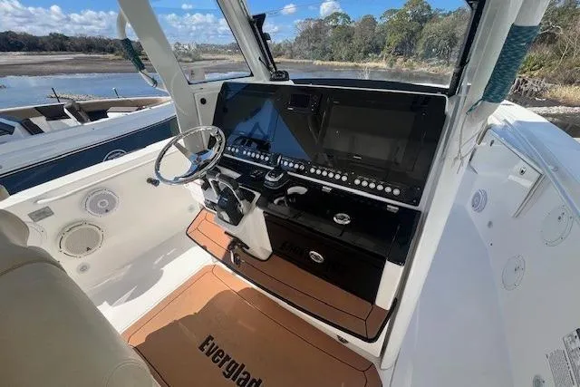 Slide: The Image of 2018 Everglades 335 Center Console boat interior with modern dashboard and steering wheel. - 20