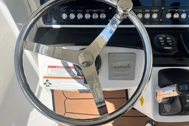 Slide: The Image of Steering wheel of 2018 Everglades 335 Center Console with Garmin navigation system. - 27