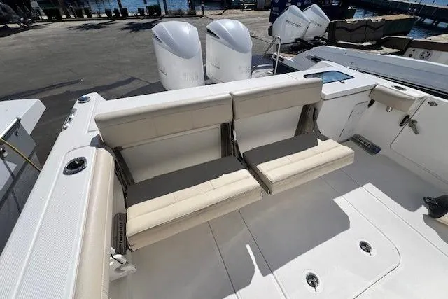 Slide: The Image of 2018 Everglades 335 Center Console boat with dual outboard engines and cushioned seating. - 30