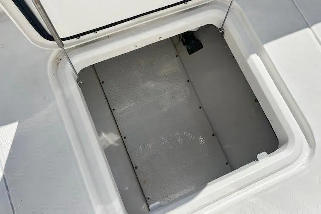 Slide: The Image of Open storage compartment on 2018 Everglades 335 Center Console boat. - 31