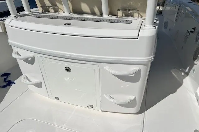 Slide: The Image of 2018 Everglades 335 Center Console boat interior with storage compartments and rod holders. - 34
