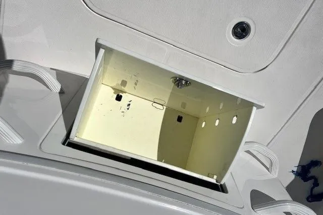 Slide: The Image of Open storage compartment on 2018 Everglades 335 Center Console boat. - 36