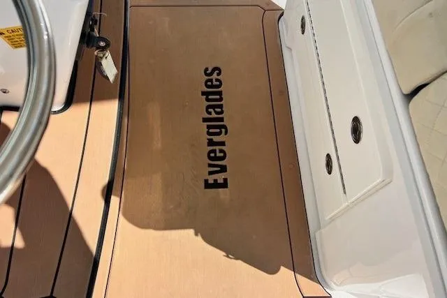 Slide: The Image of 2018 Everglades 335 Center Console boat deck with logo and steering wheel. - 39