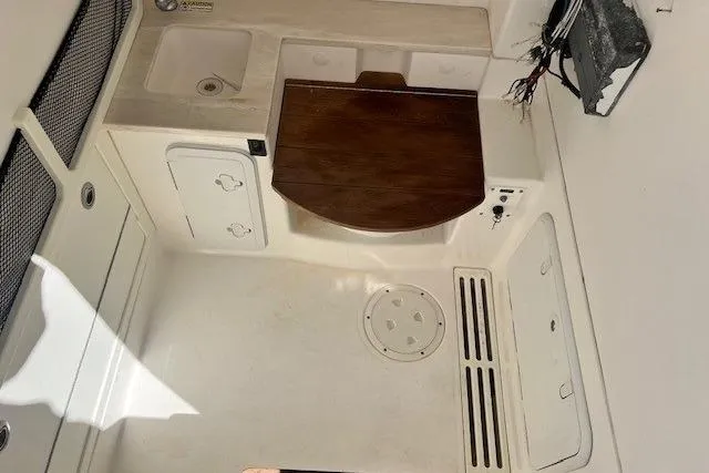 Slide: The Image of 2018 Everglades 335 Center Console interior with sink and storage compartments. - 40