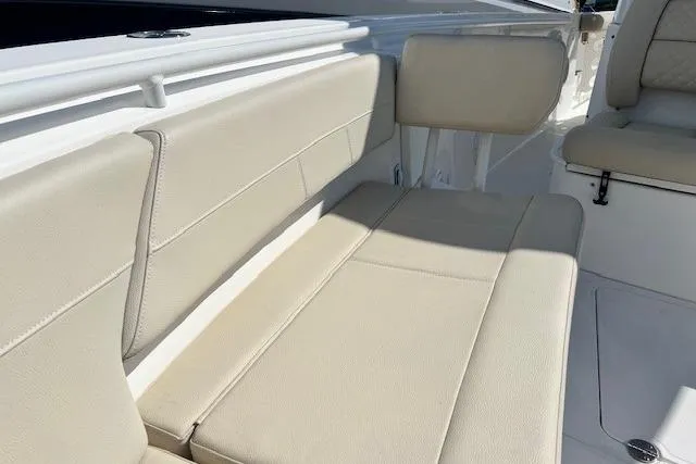 Slide: The Image of 2018 Everglades 335 Center Console boat with beige seating and sleek design. - 41