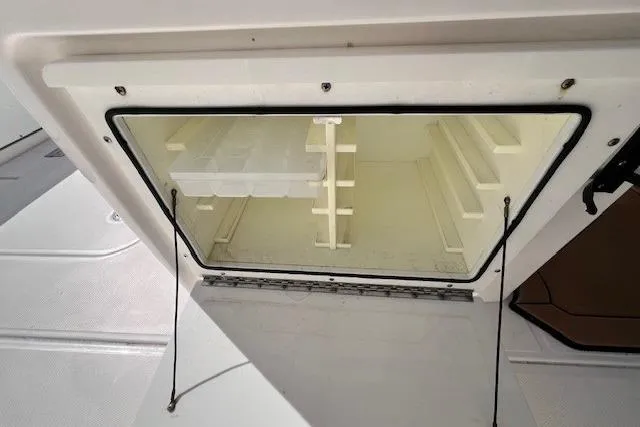 Slide: The Image of Open storage compartment on 2018 Everglades 335 Center Console boat. - 46