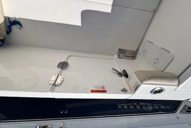 Slide: The Image of 2018 Everglades 335 Center Console boat interior with storage compartment and latch. - 48
