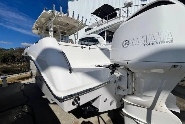 Slide: The Image of 2018 Everglades 335 Center Console boat with Yamaha four-stroke engine, docked outdoors. - 7