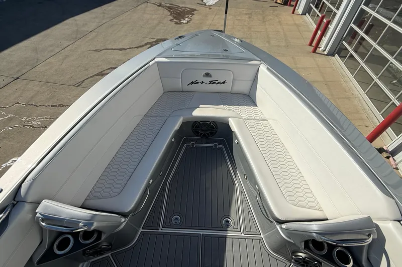 Slide: The Image of 2023 Nor-Tech 390 Sport Center Console boat with luxurious seating and modern design. - 11