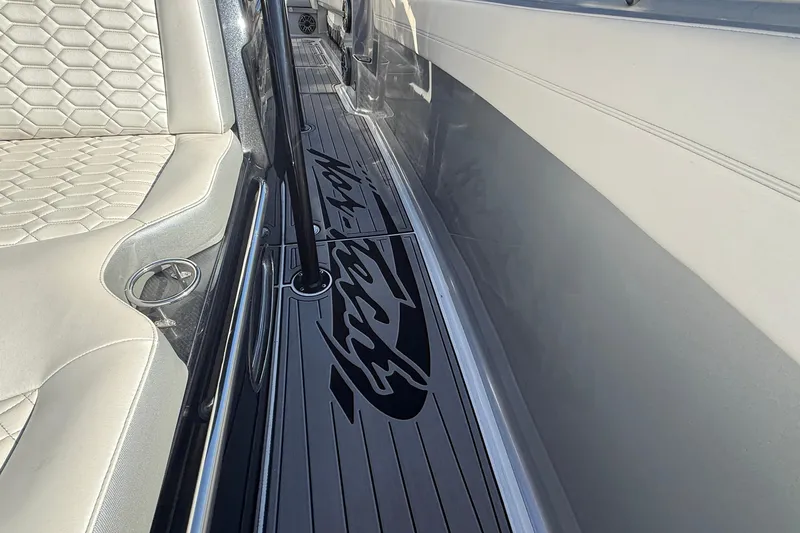 Slide: The Image of 2023 Nor-Tech 390 Sport Center Console interior with sleek seating and logo detail. - 12