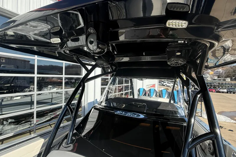 Slide: The Image of 2023 Nor-Tech 390 Sport Center Console with sleek black T-top and modern design features. - 13