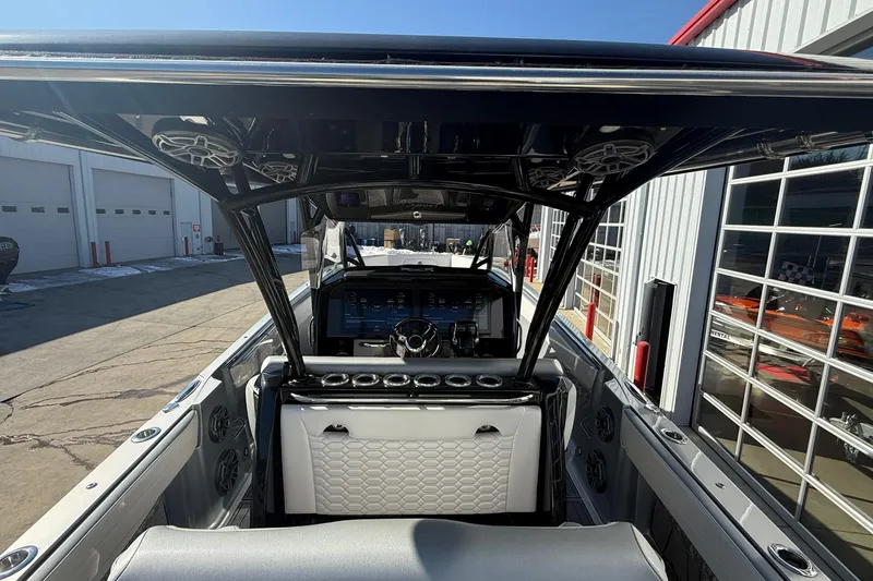 Slide: The Image of 2023 Nor-Tech 390 Sport Center Console interior with modern dashboard and seating. - 19