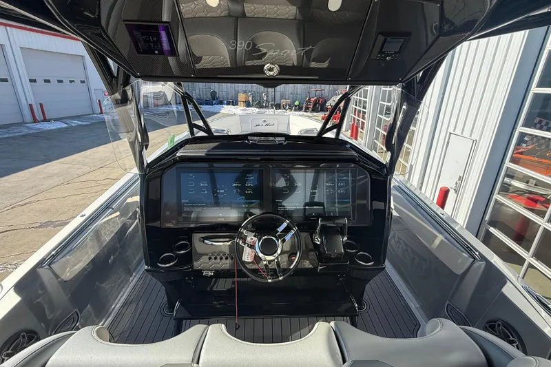 Slide: The Image of 2023 Nor-Tech 390 Sport Center Console helm with advanced navigation displays and controls. - 21