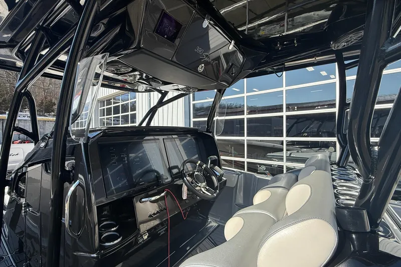 Slide: The Image of 2023 Nor-Tech 390 Sport Center Console interior with modern dashboard and seating. - 22