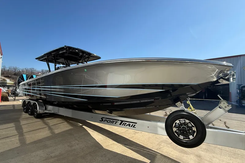 Slide: The Image of 2023 Nor-Tech 390 Sport Center Console boat on trailer under clear blue sky. - 27