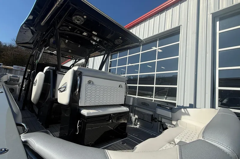 Slide: The Image of 2023 Nor-Tech 390 Sport Center Console boat interior with modern seating and sleek design. - 7