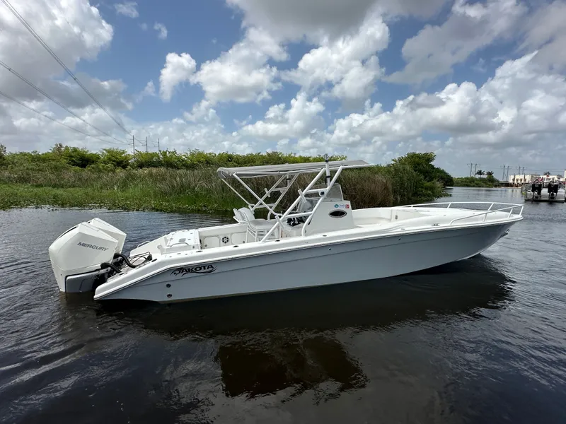 Slide: The Image of 2006 Dakota 36 Cuddy boat on calm water. - 10