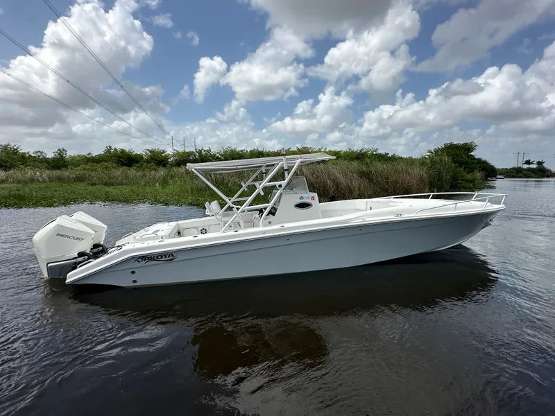 Slide: The Image of 2006 Dakota 36 Cuddy boat on calm water. - 11
