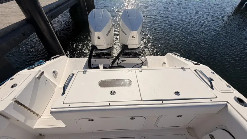 Slide: The Image of Rear view of a 2006 Dakota 36 Cuddy boat with twin outboard engines. - 3