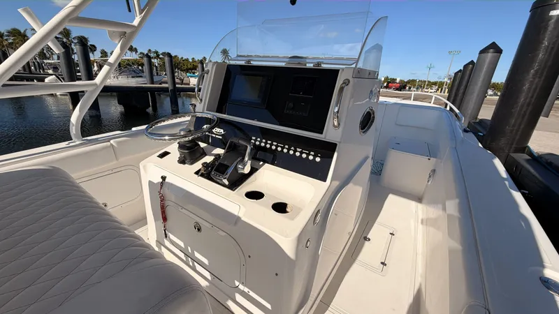 Slide: The Image of 2006 Dakota 36 Cuddy boat helm at the dock. - 4