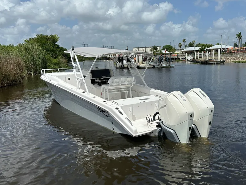 Slide: The Image of 2006 Dakota 36 Cuddy boat with twin engines on calm water. - 9