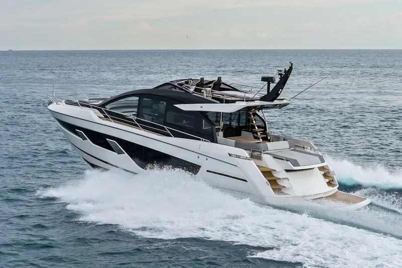 Slide: The Image of 2022 Sunseeker 65 Sport Yacht cruising on open water, showcasing sleek design and luxury. - 13