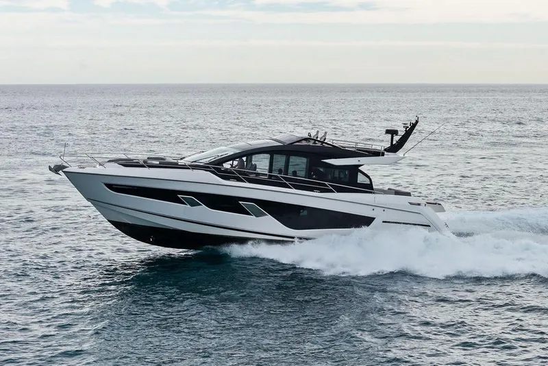Slide: The Image of 2022 Sunseeker 65 Sport Yacht cruising on open water. - 14