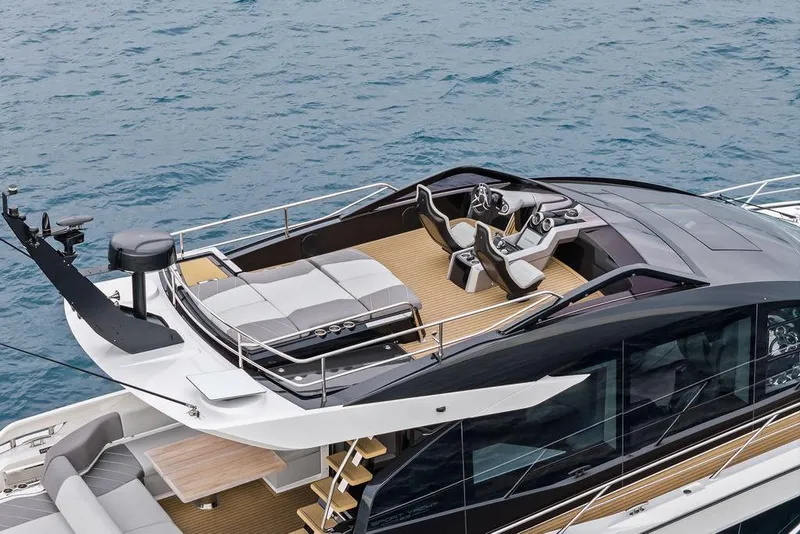 Slide: The Image of 2022 Sunseeker 65 Sport Yacht with sleek design and luxurious deck on the water. - 23