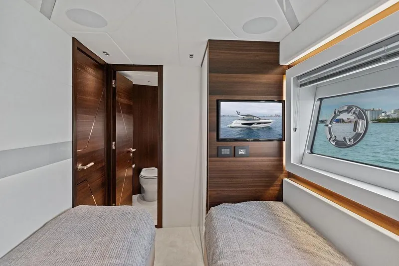 Slide: The Image of Interior of 2022 Sunseeker 65 Sport Yacht cabin with twin beds and ocean view. - 31