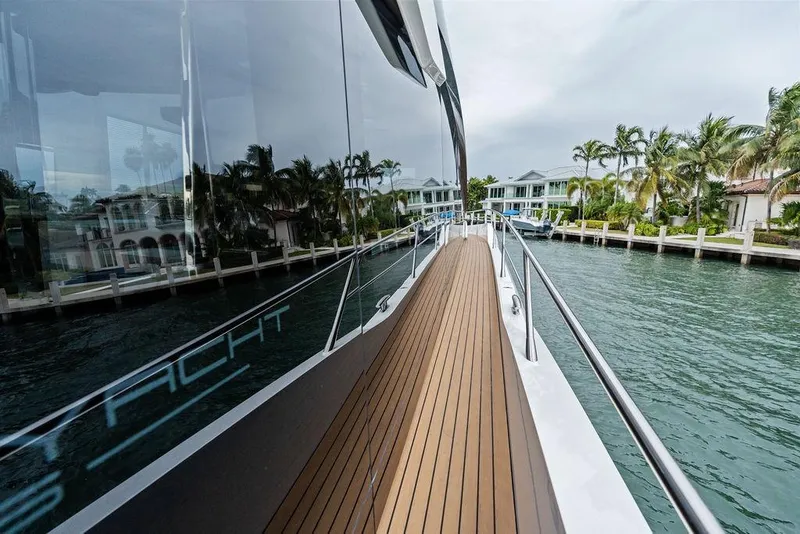 Slide: The Image of 2022 Sunseeker 65 Sport Yacht deck with waterfront view and luxury homes. - 45